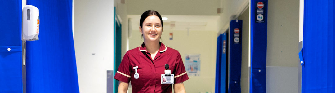 Midwife walking in Murray ward corridor